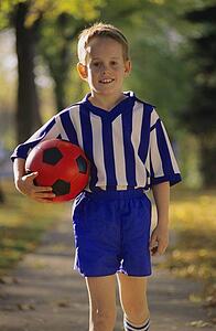 Young boy wearing soccer uniform