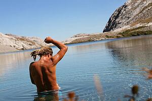Man bathing in mountain lake