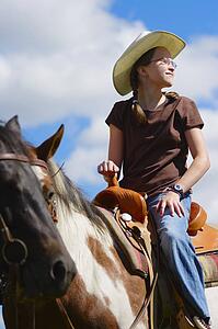 Young girl riding horse