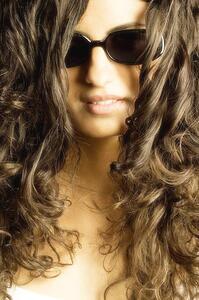 Young woman with curls and glasses