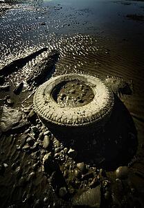 Old tire abandoned on beach