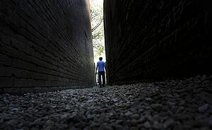 Man walking between buildings
