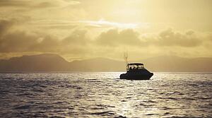 Boat on water at sunrise