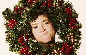 Young boy in Christmas wreath