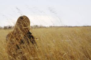 Woman sitting in field