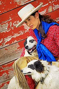 Cowgirl with two dogs