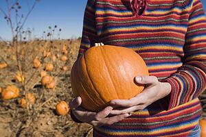 Woman holding a pumpkin
