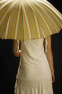 Woman facing away with umbrella