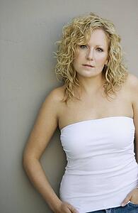 Young woman leaning against wall
