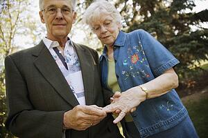 Man placing ring on finger