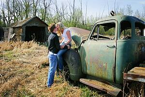 Couple kissing on old truck