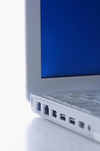 Close-up of laptop computer with no cables plugged in.