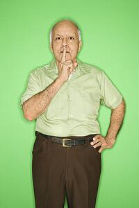 Caucasian mature adult male with finger up to mouth.