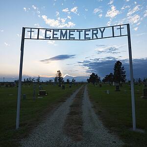 Sign over entrance to cemetary at dusk in rural South Dakota.