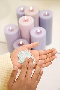 Asian/Indian young womans hands with facial scrub.