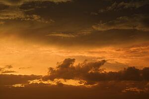 Golden yellow and orange sunset sky and clouds.
