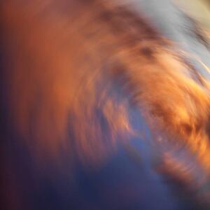 Spiral orange clouds in sky with sunset.