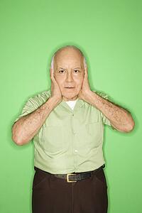 Caucasian mature adult male with hands over ears.