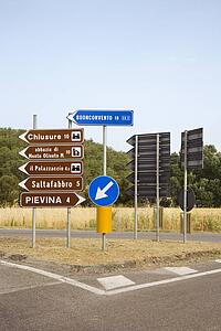 Road signs pointing different directions, Tuscany.