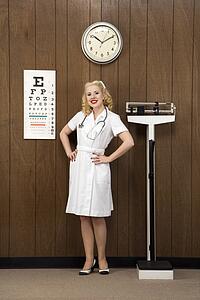 Caucasian mid-adult female nurse with hands on hips smiling at viewer in retro doctor's office.