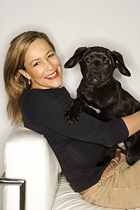 Caucasian prime adult female with black puppy.