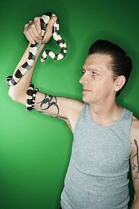 Caucasian mid-adult male holding California Kingsnake.
