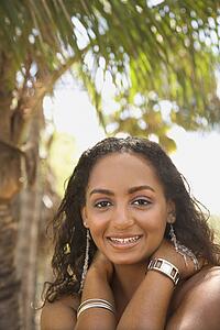 Young-adult Black female smiling and making eye contact.