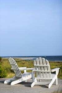 Adirondack chairs looking towards beach on Bald Head Island North Carolina