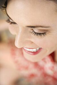 Close-up of mid-adult Caucasian woman smiling.