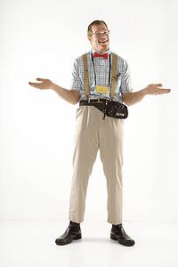 Caucasian young man dressed like nerd shrugging his shoulders.
