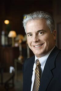 Caucasian prime adult male businessman in hotel lobby.