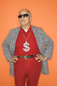 Mature adult Caucasian male wearing money sign necklace.