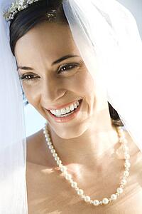 Portrait of Caucasian mid-adult bride smiling.