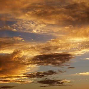 Golden clouds in sky with sunset.
