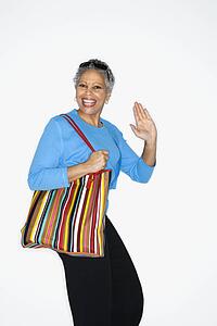 African American mature adult female holding big purse.