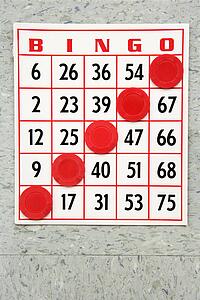 Red bingo card with winning chips.