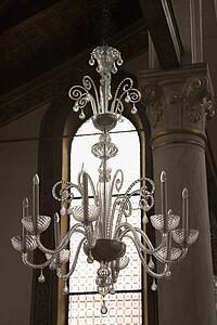 Decorative ornate crystal chandelier hanging from ceiling.