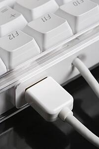 Close-up of cords connected to computer keyboard.