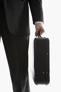 Caucasian mid-adult man's hand holding briefcase.