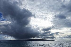 Kahoolawe, Hawaii with ocean and cloudy sky.