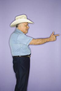 Caucasian mature adult male wearing cowboy hat.