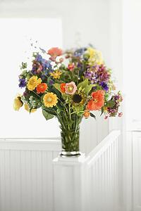 Colorful flowers arranged in vase.