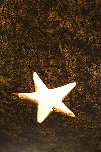 Close-up of decorative glowing star shape in metal lamp