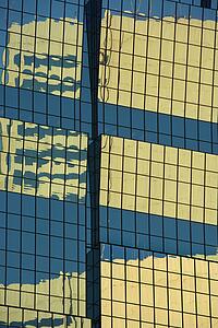 Abstract close-up of side of urban building reflecting sunlight