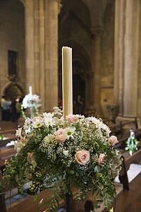 Interior with flower bouquet and candle of Se Cathedral, Lisbon, Portugal.