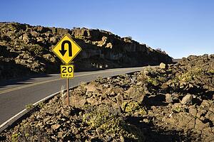 Road and curve in road sign in Haleakala National Park, Maui, Hawaii