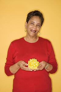 African American mature adult female holding present.