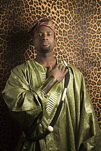 Portrait of African- American mid-adult man wearing traditional African clothing.