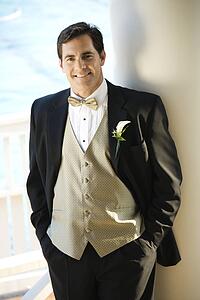  Portrait of Caucasian mid-adult groom in tuxedo smiling.