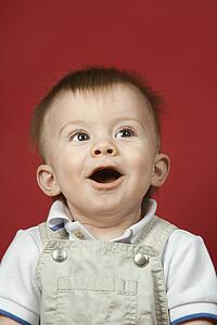 Portrait of Caucasian male child looking surprised.